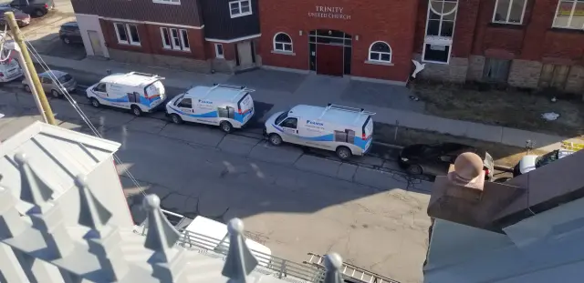 Outdoor Gree heat pump with blue and white branding installed on a residential property