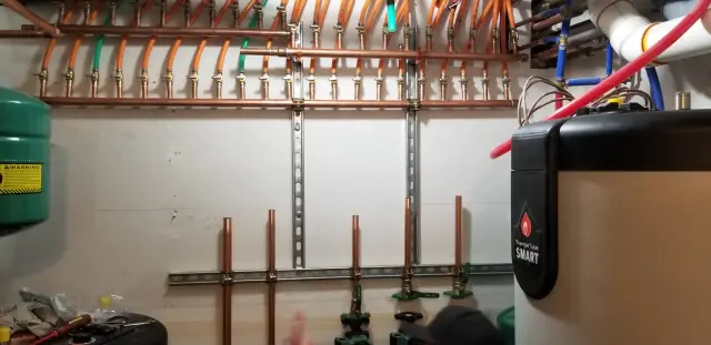 Copper pipes with fittings and connections, organized in a horizontal manner