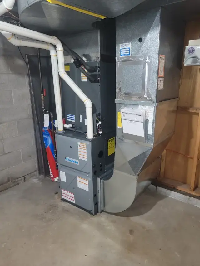 Image of HVAC system with Daikin unit installed, showing the metal ductwork and the electrical connections