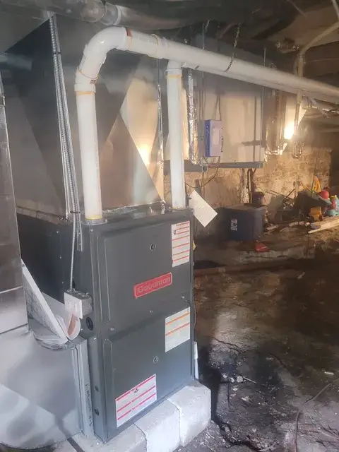 A technician is closely examining an HVAC unit, highlighting the importance of regular maintenance for efficient heating and cooling systems.