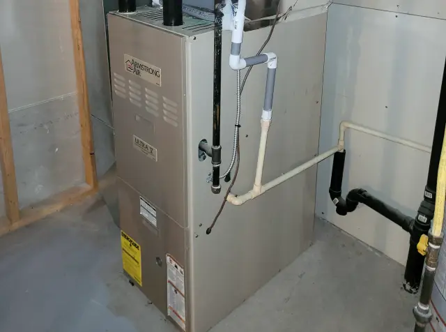 Image of an HVAC unit with visible piping and wiring