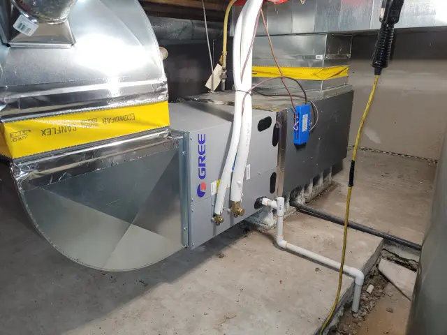 Outdoor heat pump installed by a , with the Gree brand clearly visible on the equipment