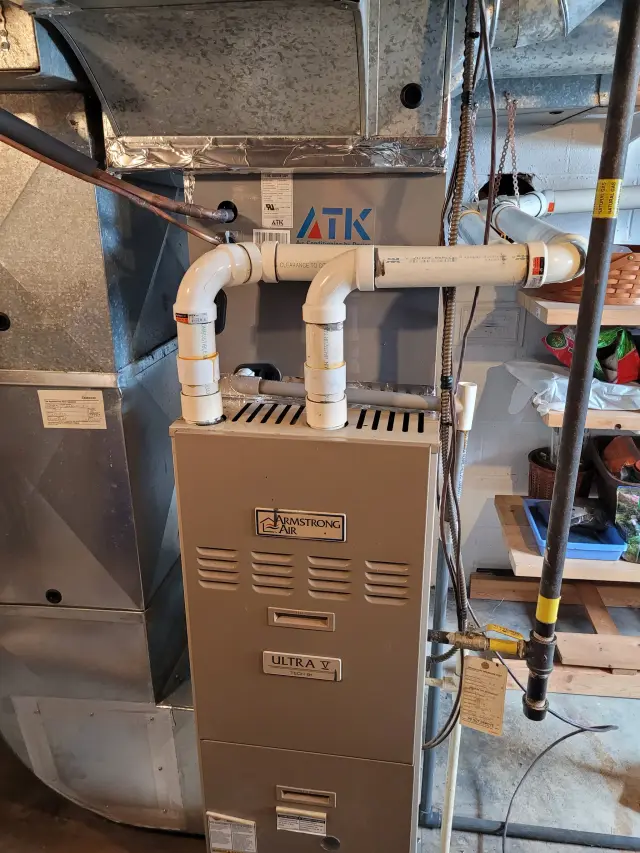 Image of an HVAC unit with visible piping and wiring