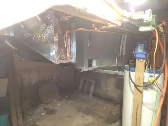 Water heater with wiring and control box installed in a cluttered space