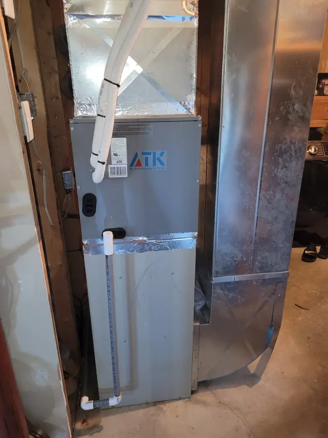 Outdoor Gree heat pump installed on concrete foundation with metal framework