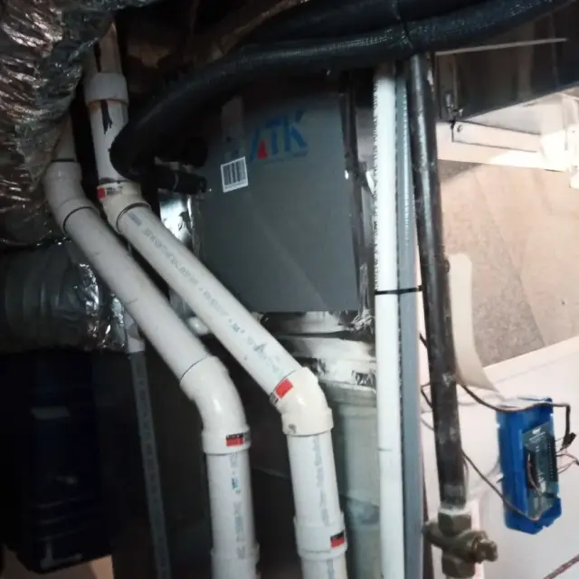 Outdoor Gree heat pump installed on concrete slab with metal framework