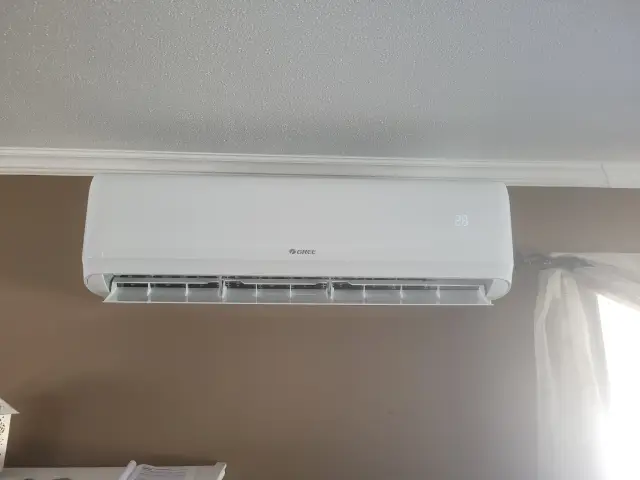 A white air conditioning unit is mounted on a wall