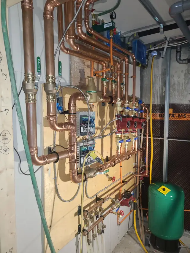 Copper pipes with valves and fittings installed on a wall