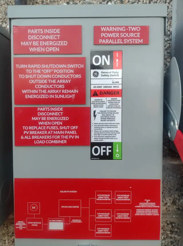 An electrical box with red warning labels and instructions for safe operation of a solar power system