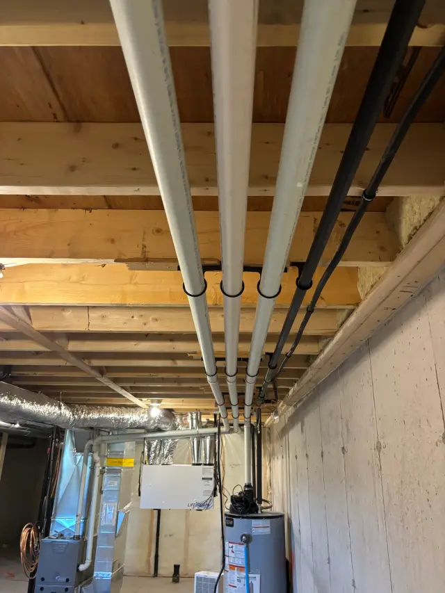 Radiant floor heat tubing is neatly arranged on insulation, ready for connection to the heating system