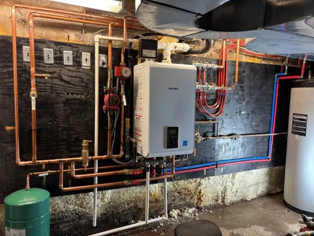 Copper pipes for heating system, with red and blue lines indicating different fluid paths