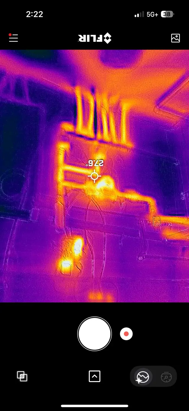 Outdoor Gree heat pump with a white casing and a red logo, placed on a concrete surface with