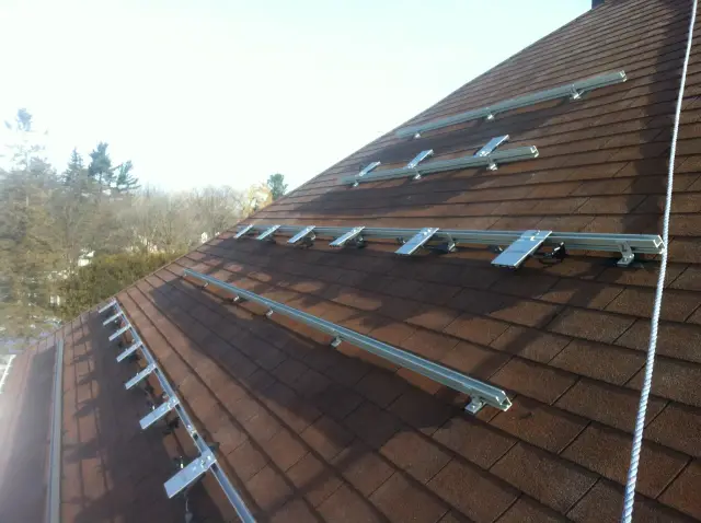 Solar panels on roof with metal brackets and wiring