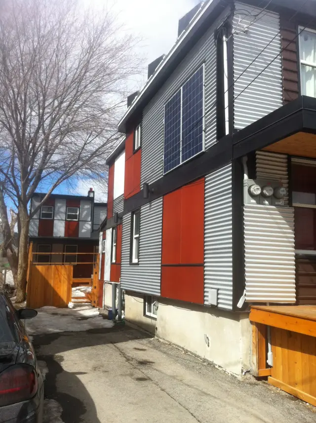 Solar panels are installed on the side of a house, providing clean energy to the residence