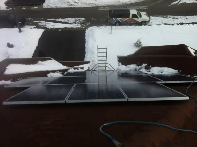 Solar panels on a roof with snow around
