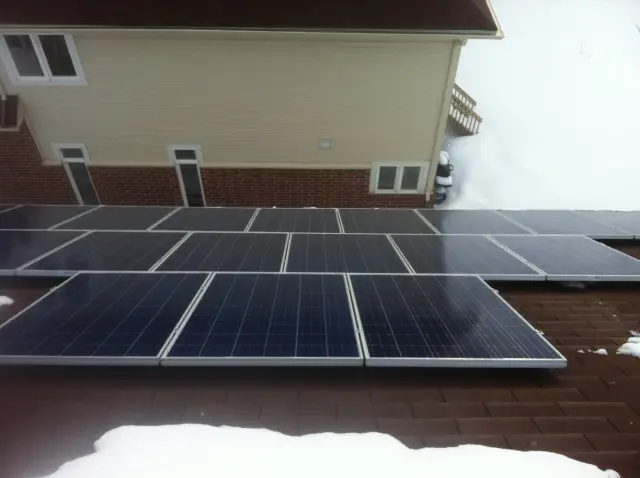 Solar panels on a roof with snow around them